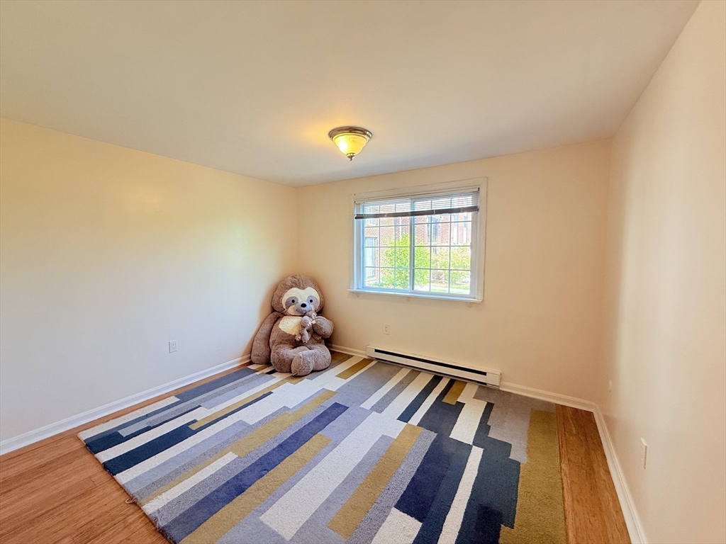 388 Great Road, Unit A1 Acton, MA 01720 - Photo 7 of 18 a view of a room with toys and wooden floor