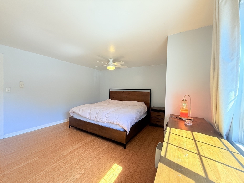 388 Great Road, Unit A1 Acton, MA 01720 - Photo 9 of 18 a bedroom with a bed and wooden floor