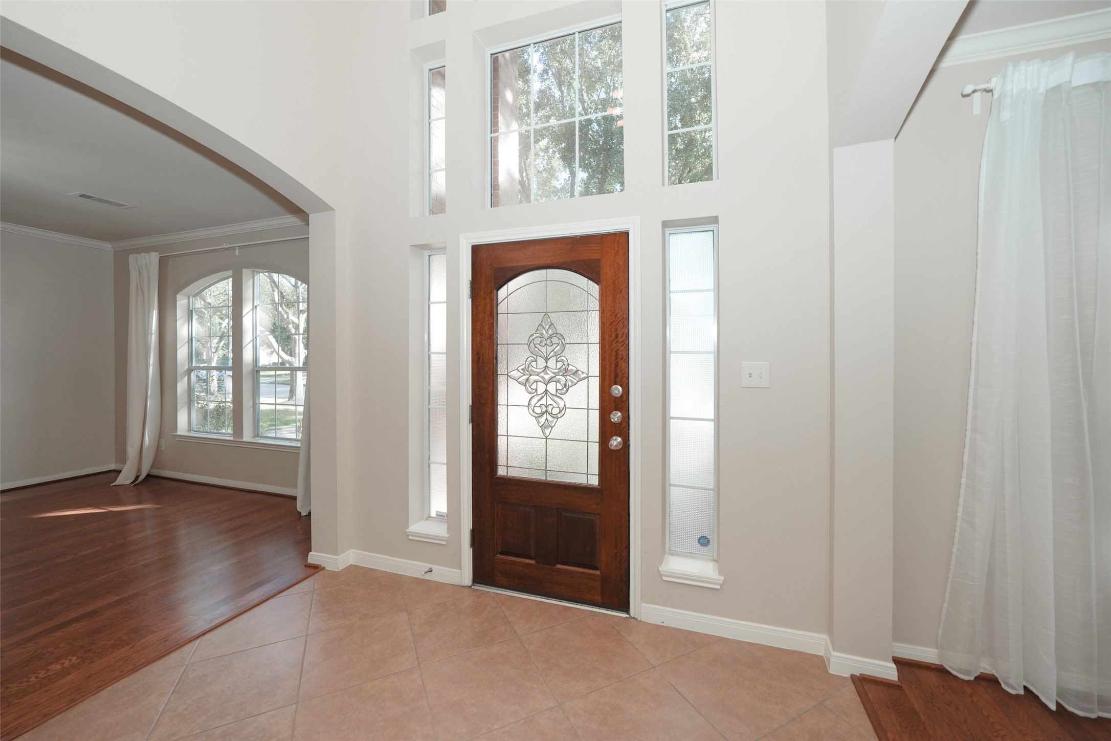 4415 Eden Point Lane Katy, TX 77494 - Photo 4 of 13 an empty room with windows ceiling fan and wooden floor