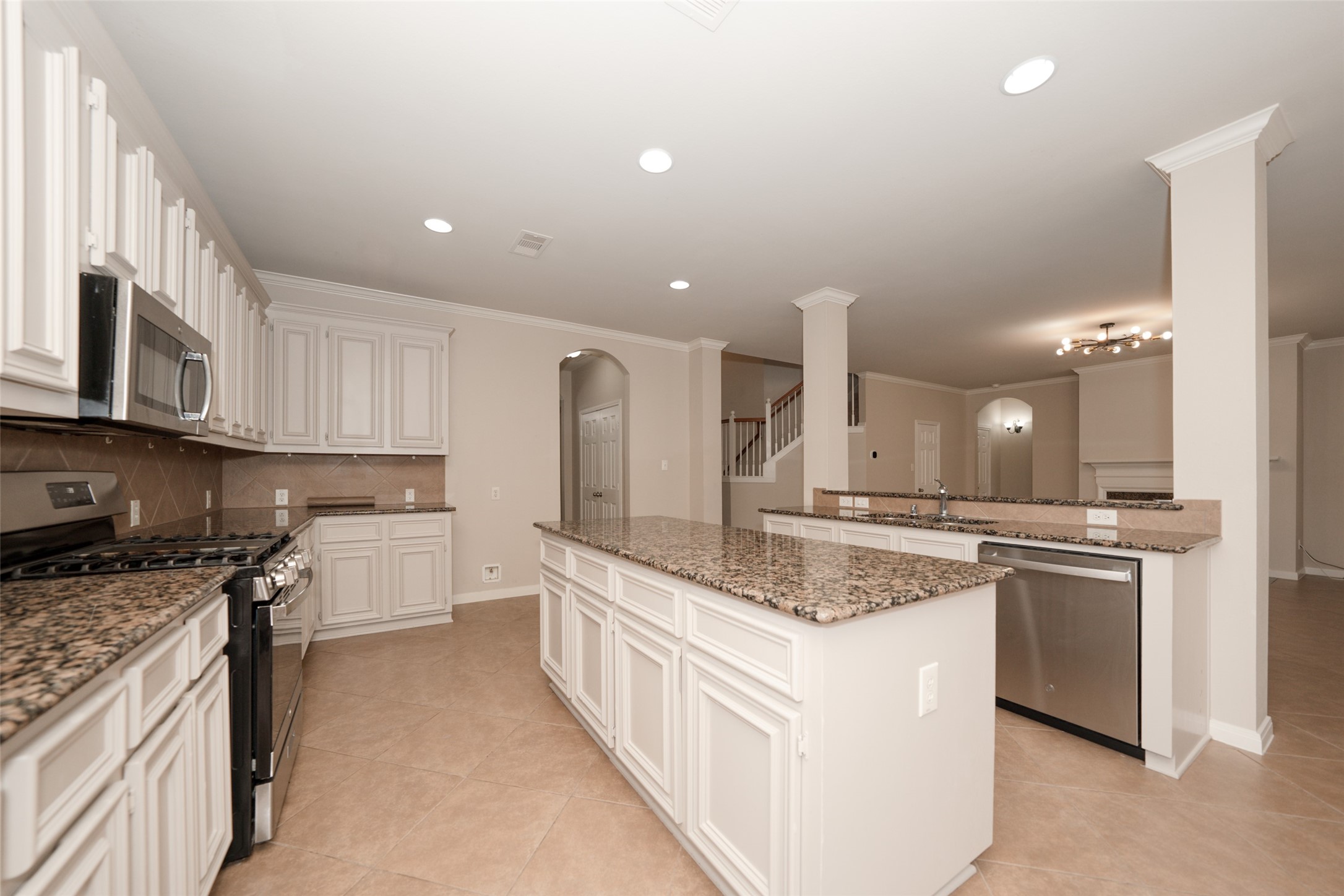 4415 Eden Point Lane Katy, TX 77494 - Photo 6 of 13 a large kitchen with stainless steel appliances granite countertop a stove a sink and a refrigerator