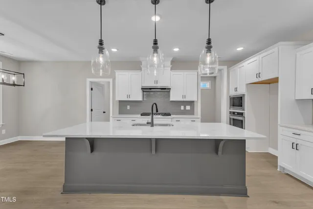 a view of empty room with wooden floor and windows