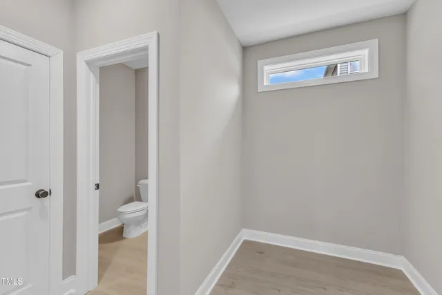 an empty room with windows and closet