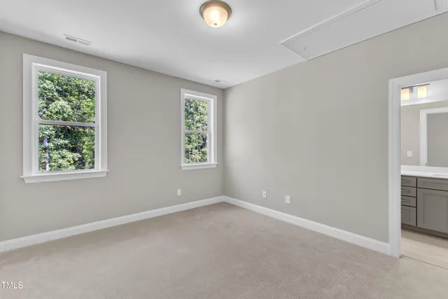a bathroom with a granite countertop sink a mirror and shower