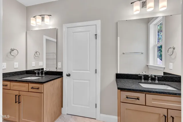 a view of a big house with a big yard and large trees