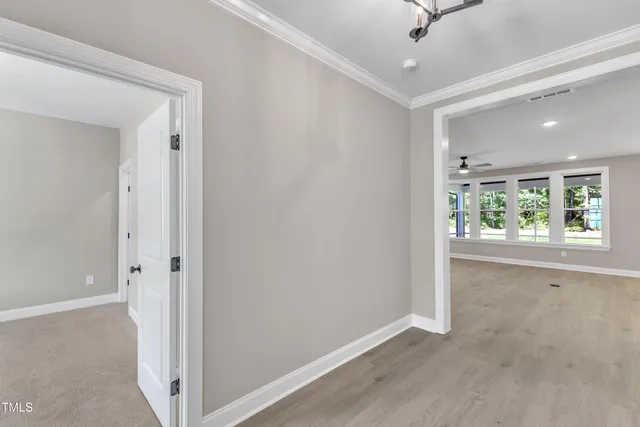 a view of an empty room with a fireplace and a window