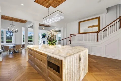 a spacious bathroom with a sink a large mirror and vanity