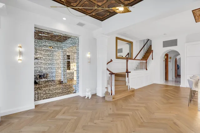 a view of a livingroom with a staircase and a cabinet