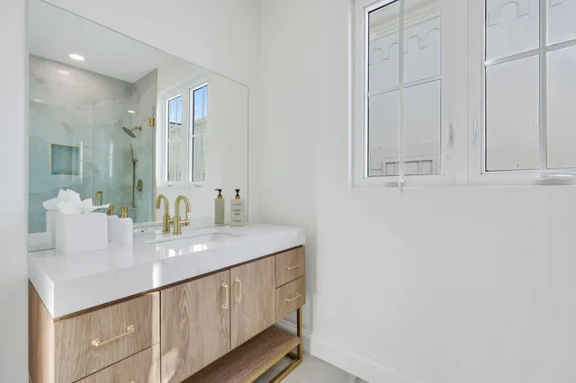 a bathroom with a glass shower door