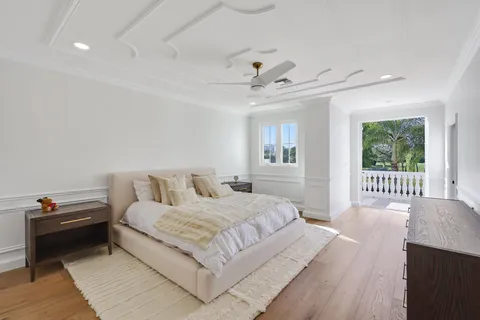 a bedroom with a bed next to a window