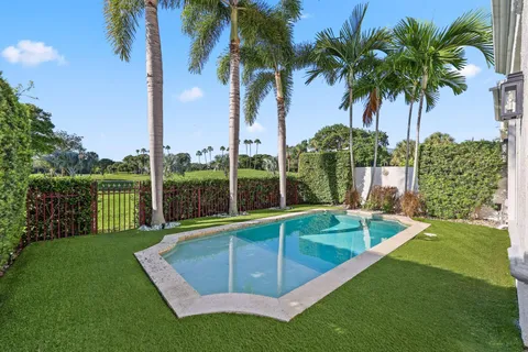 a view of a backyard with swimming pool