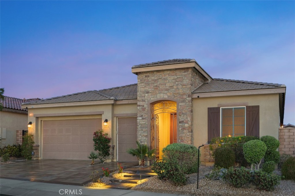 a front view of a house with garden
