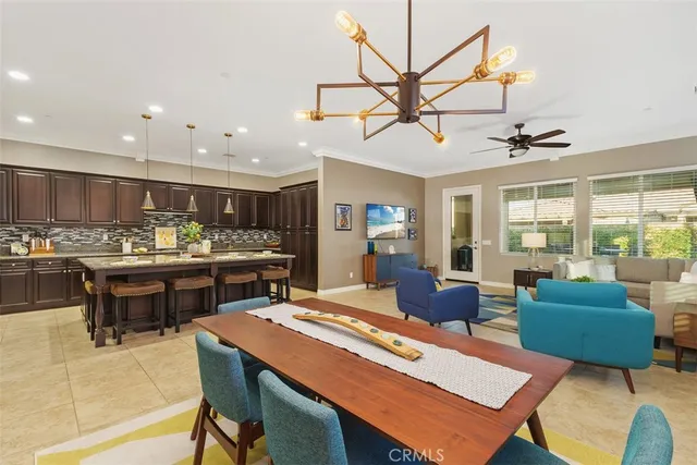 a kitchen with a sink cabinets and chairs