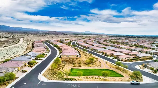 an aerial view of residential building with yard