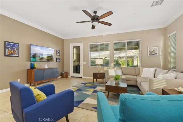 a living room with furniture a rug and a window