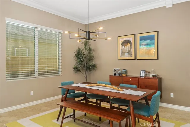 a living room with furniture kitchen view and a wooden floor