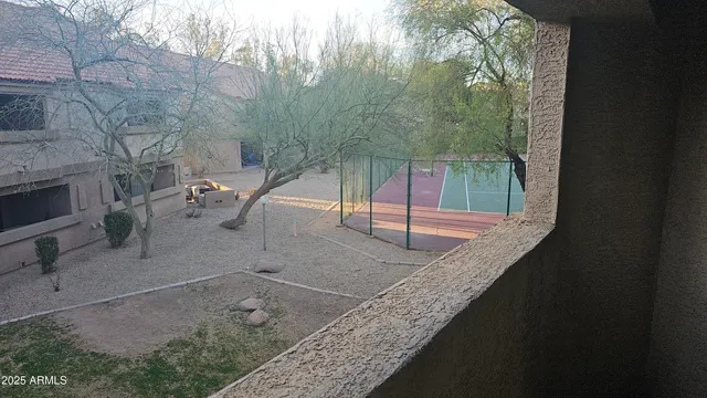 a backyard of a house with table and chairs
