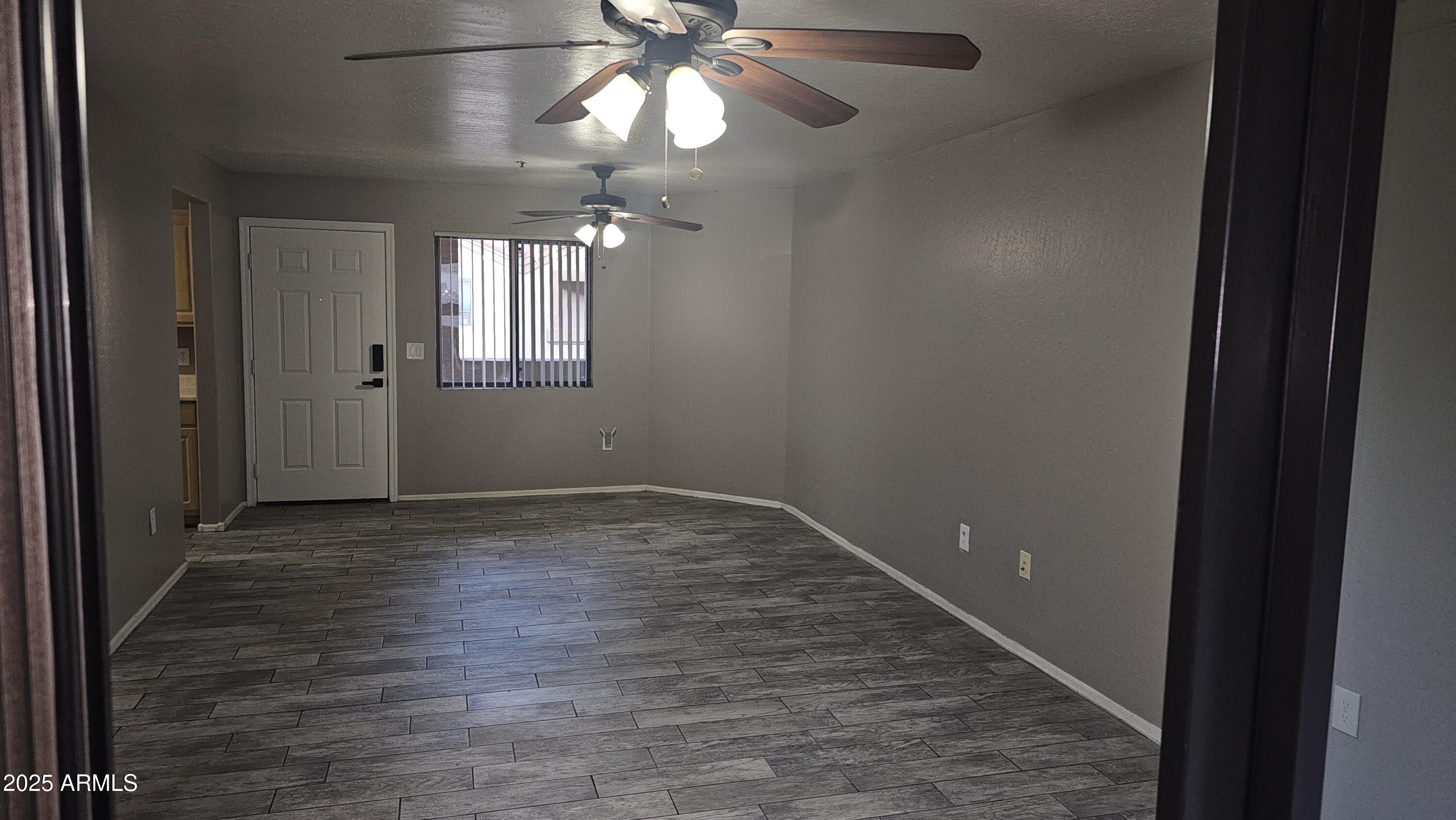 1287 North Alma School Road, Unit 262 Chandler, AZ 85224 - Photo 4 of 19 wooden floor in an empty room with a window