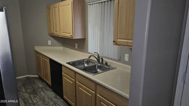 a kitchen with a sink and cabinets