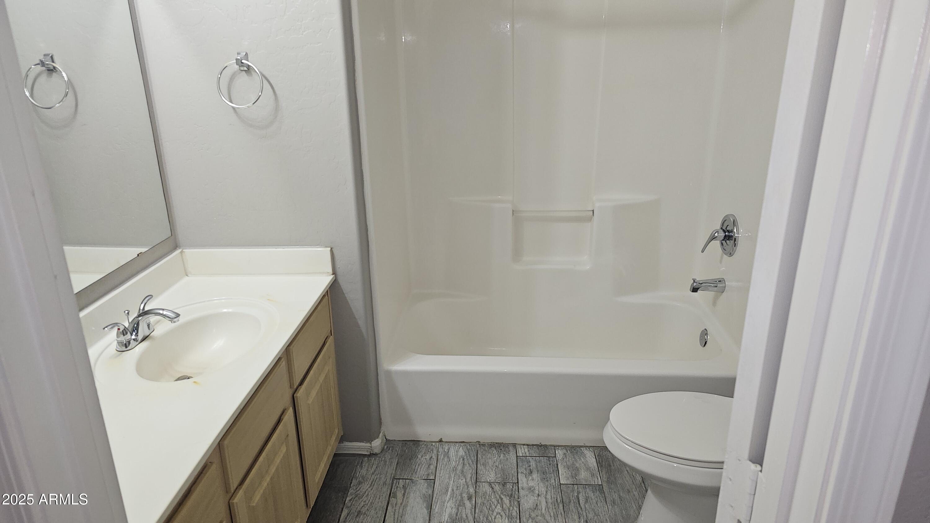 1287 North Alma School Road, Unit 262 Chandler, AZ 85224 - Photo 7 of 19 a bathroom with a sink toilet and shower