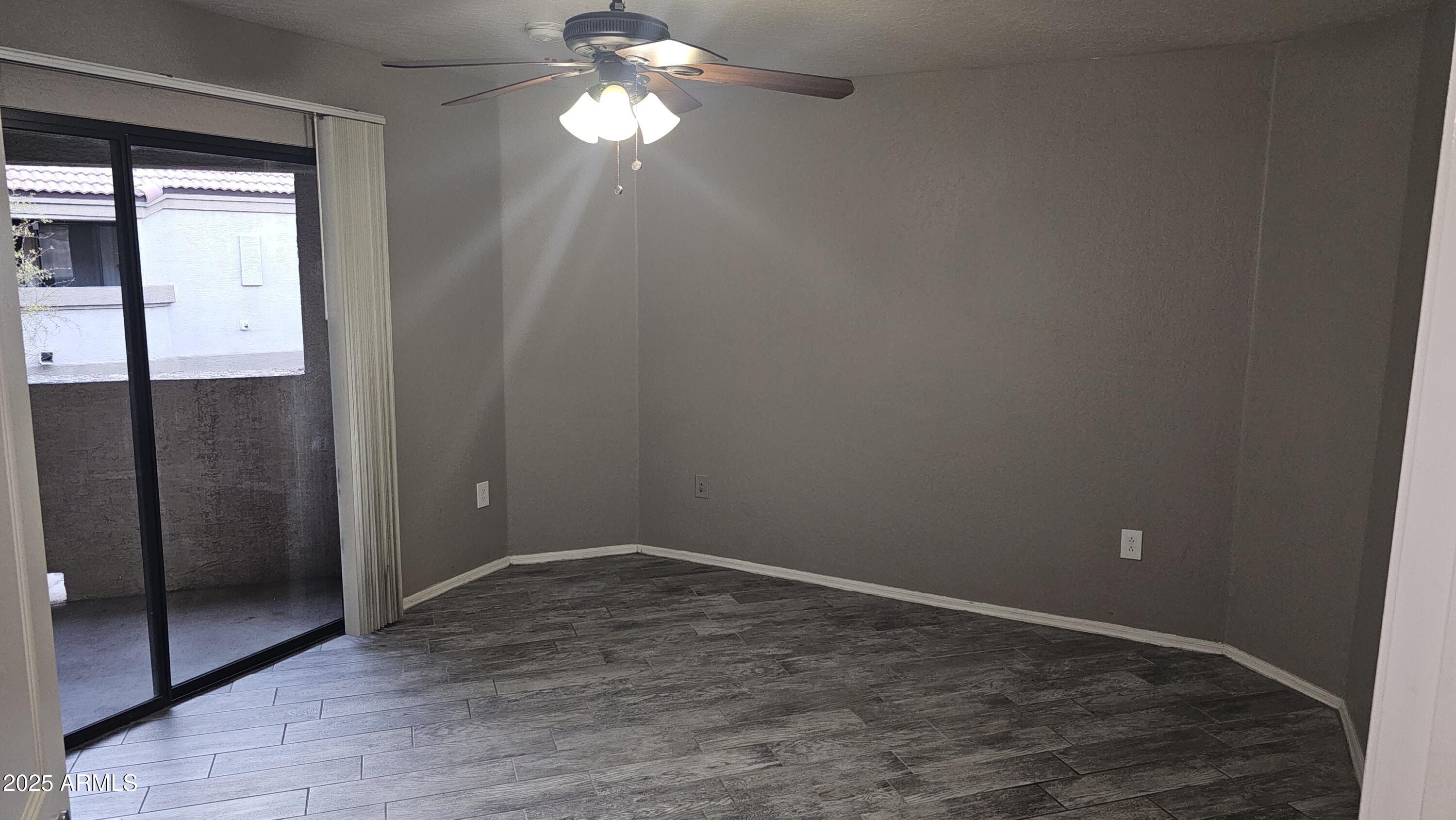 1287 North Alma School Road, Unit 262 Chandler, AZ 85224 - Photo 8 of 19 wooden floor in an empty room with a mirror