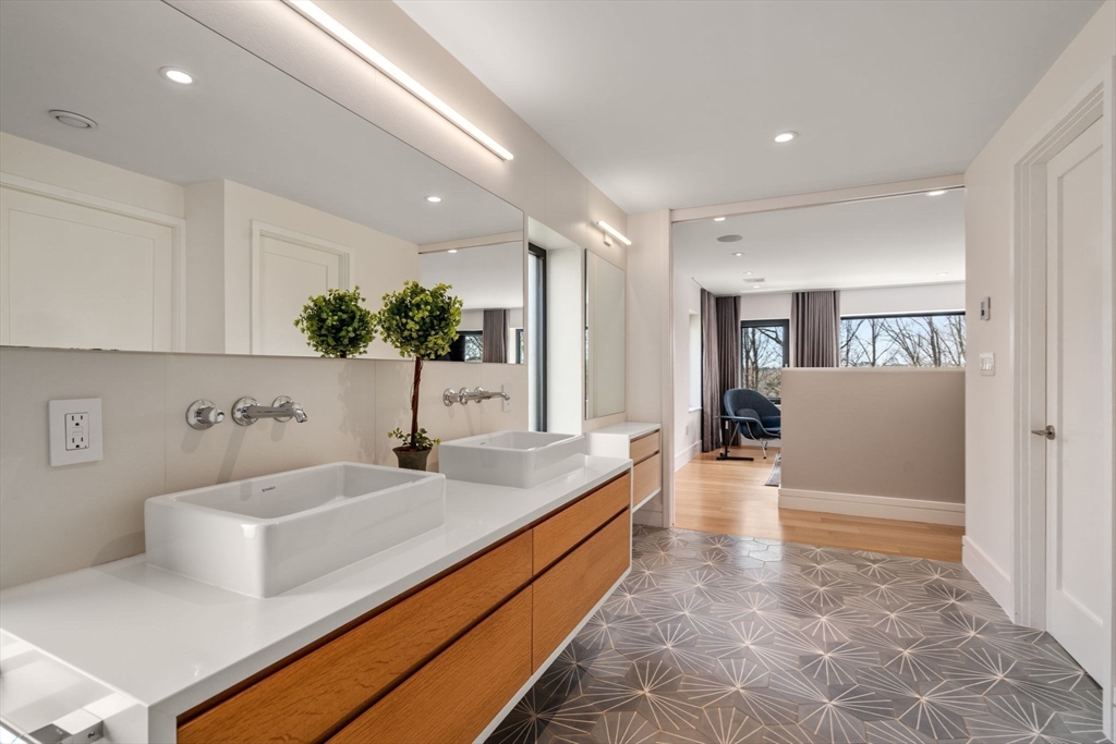 33 Leicester Street Brookline, MA 02445 - Photo 18 of 38 a hallway with a sink and cabinets