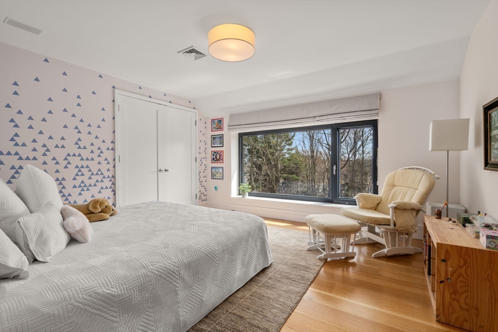 33 Leicester Street Brookline, MA 02445 - Photo 20 of 38 a bed room with a bed and a chair