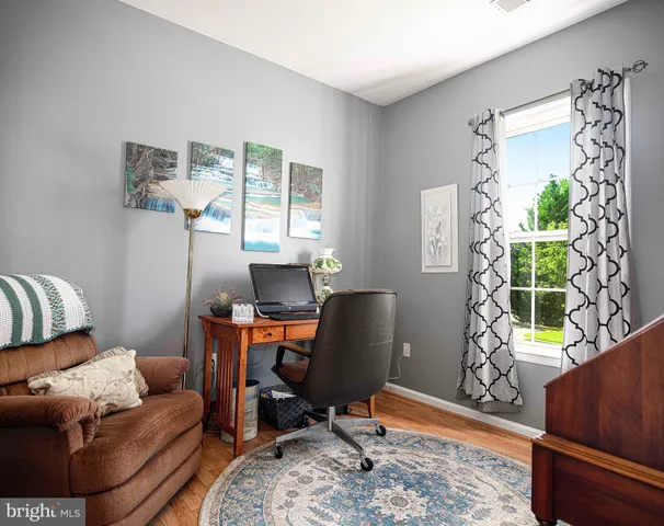 a living room with furniture rug and a window