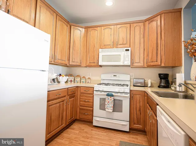 a kitchen with a stove top oven sink and cabinets