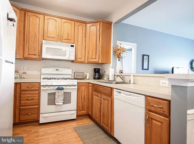 a kitchen with stainless steel appliances granite countertop a sink and cabinets