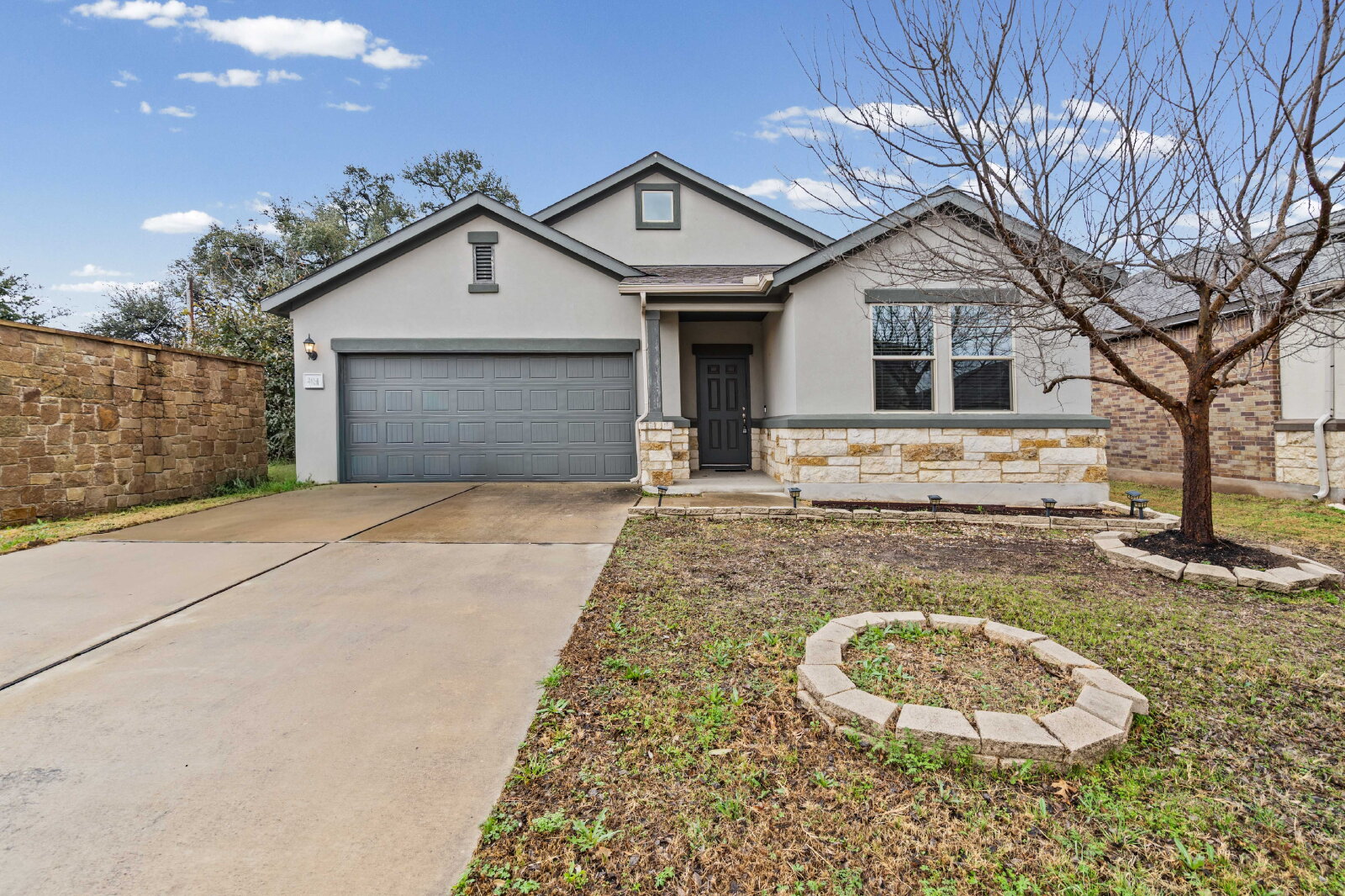 204 Tulum Terrace Leander, TX 78641 - Photo 1 of 22 View of front of house featuring stone siding, stucco siding, concrete driveway, and an attached garage