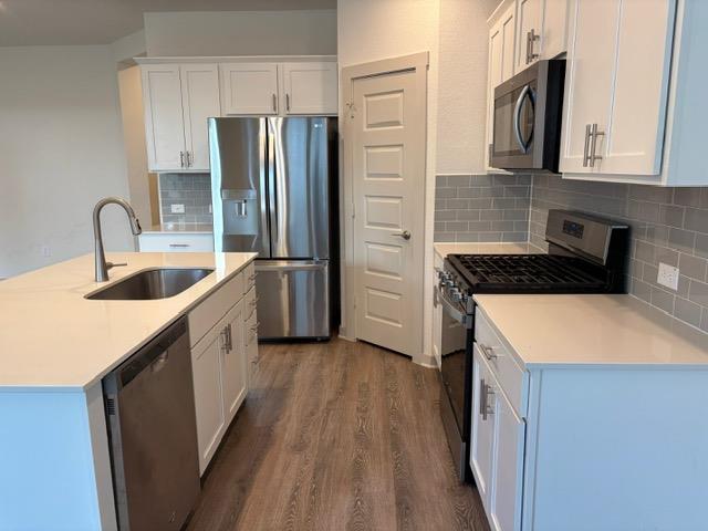 10925 Defender Trail Austin, TX 78754 - Photo 2 of 7 A well-appointed culinary space featuring sleek stainless steel appliances and abundant white cabinetry.