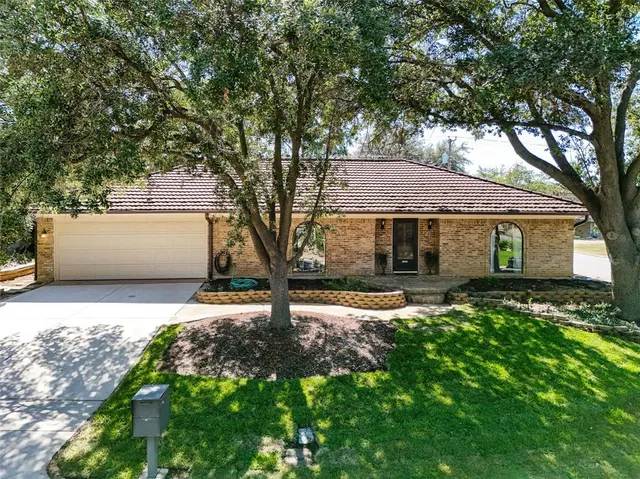 a front view of house with yard and trees