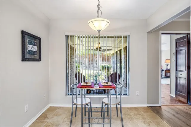 a dining room with furniture and window