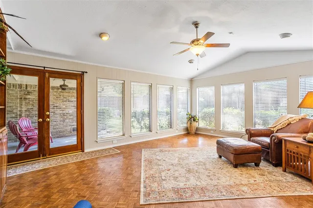a living room with furniture and a floor to ceiling window