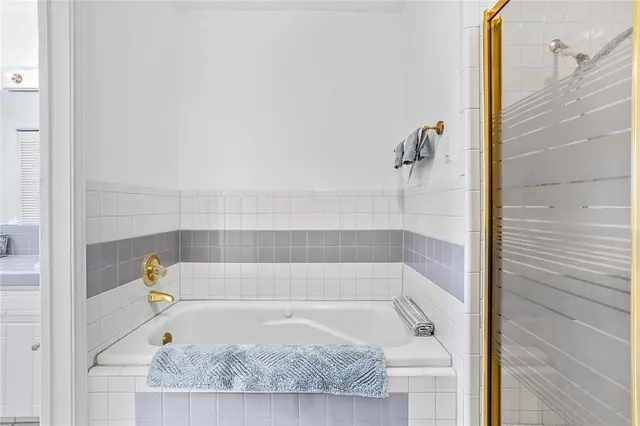 a bathroom with a bath tub and shower