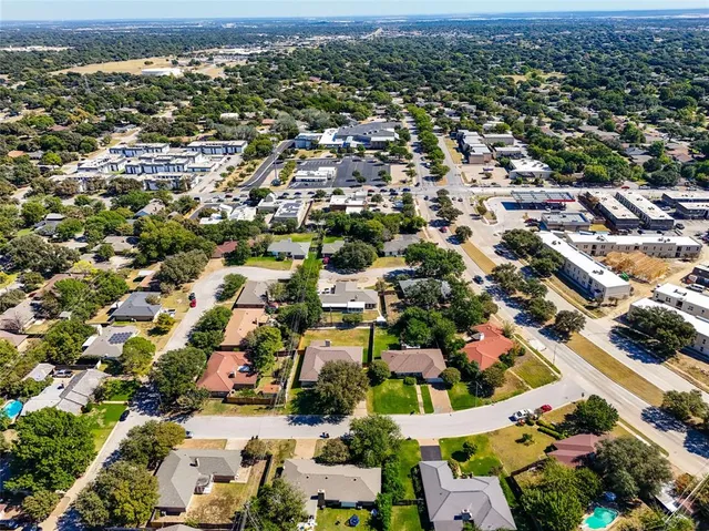 an aerial view of residential houses with outdoor space