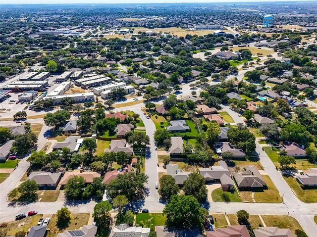 an aerial view of residential houses with outdoor space