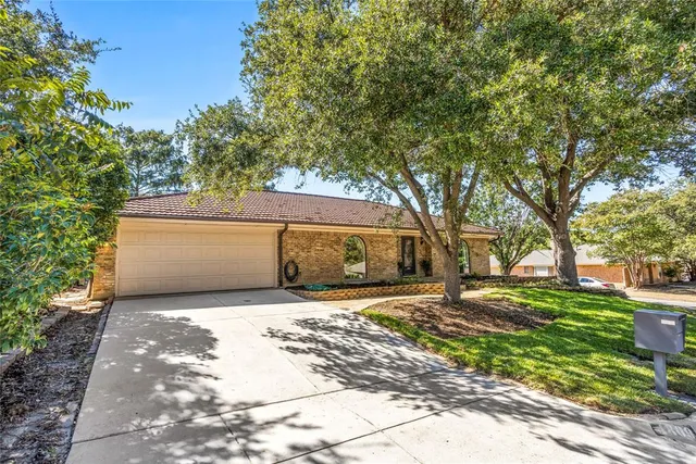 a view of a yard with a house and large tree
