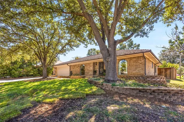 a front view of house with yard and trees