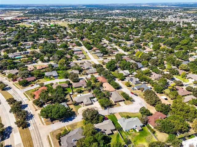 an aerial view of residential houses with outdoor space