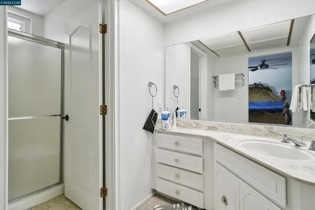 a bathroom with a granite countertop sink mirror and double