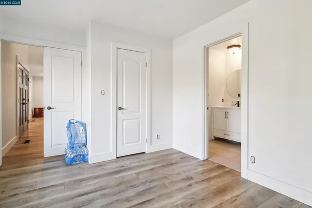 a view of empty room with wooden floor and window