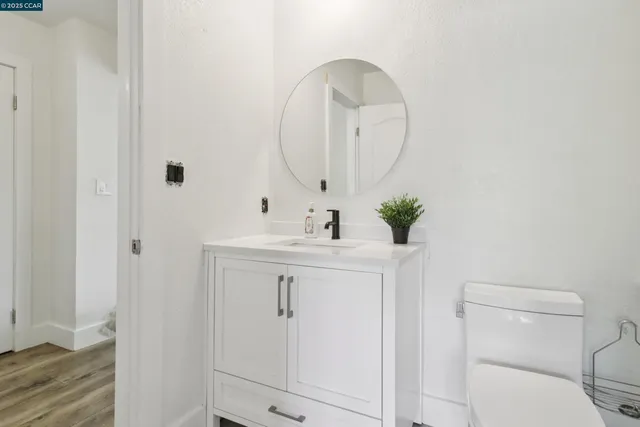 a bathroom with a sink vanity and a mirror