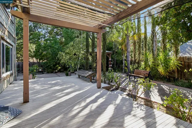 a view of a chair and table in backyard of the house