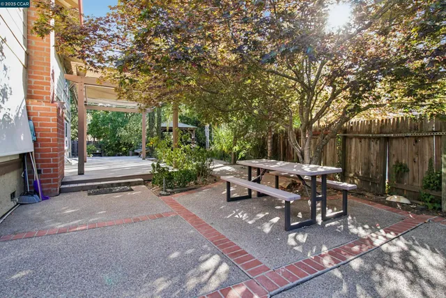 a view of backyard with table and chairs and a fire pit