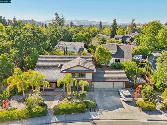 a aerial view of a house with swimming pool garden and patio