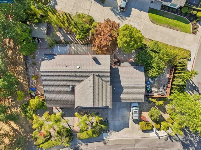 aerial view of a house with a yard and sitting area