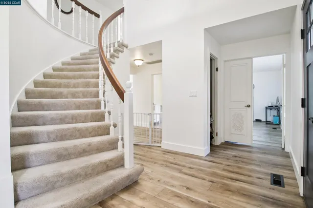 a view of entryway and hall with wooden floor