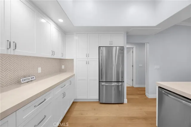 a kitchen with granite countertop a refrigerator and a sink