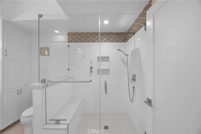 a bathroom with a shower and a glass door